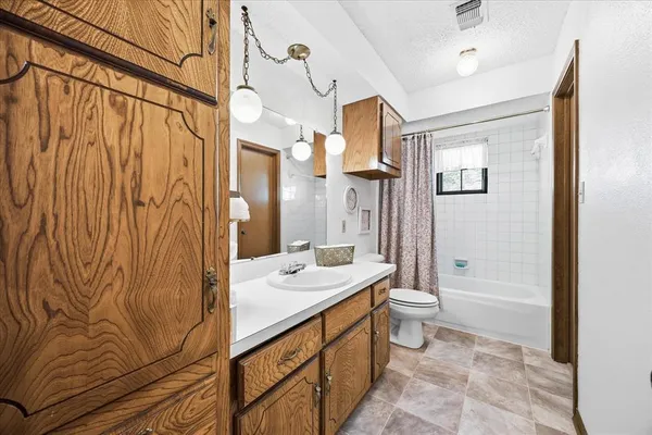 a bathroom with a double vanity sink toilet and shower