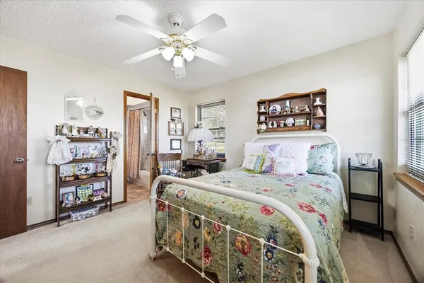 a bedroom with bed and a chandelier
