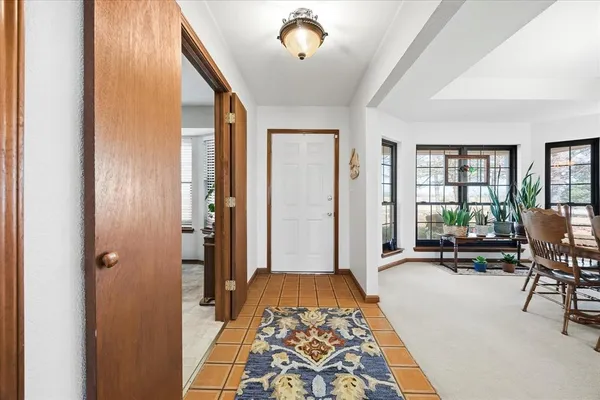a view of a hallway with workspace and a window
