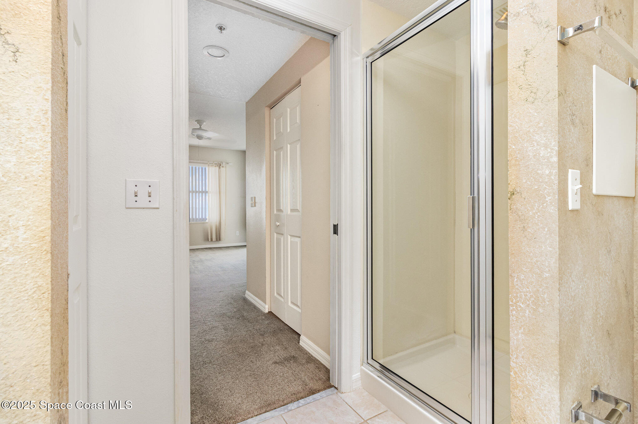 104 Riverside Drive, Unit 403 Cocoa, FL 32922 - Photo 12 of 20 a view of a bathroom with a glass shower door