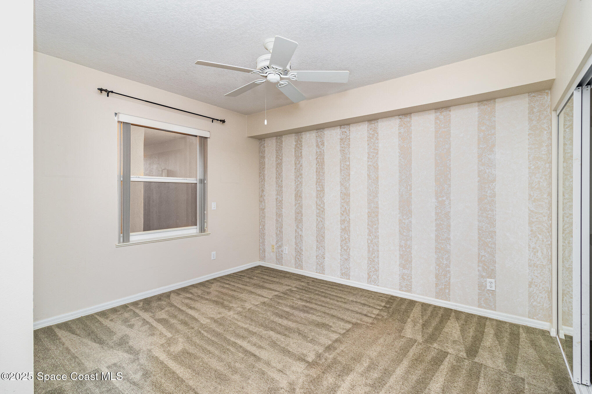 104 Riverside Drive, Unit 403 Cocoa, FL 32922 - Photo 15 of 20 a view of a livingroom with a ceiling fan and wooden floor