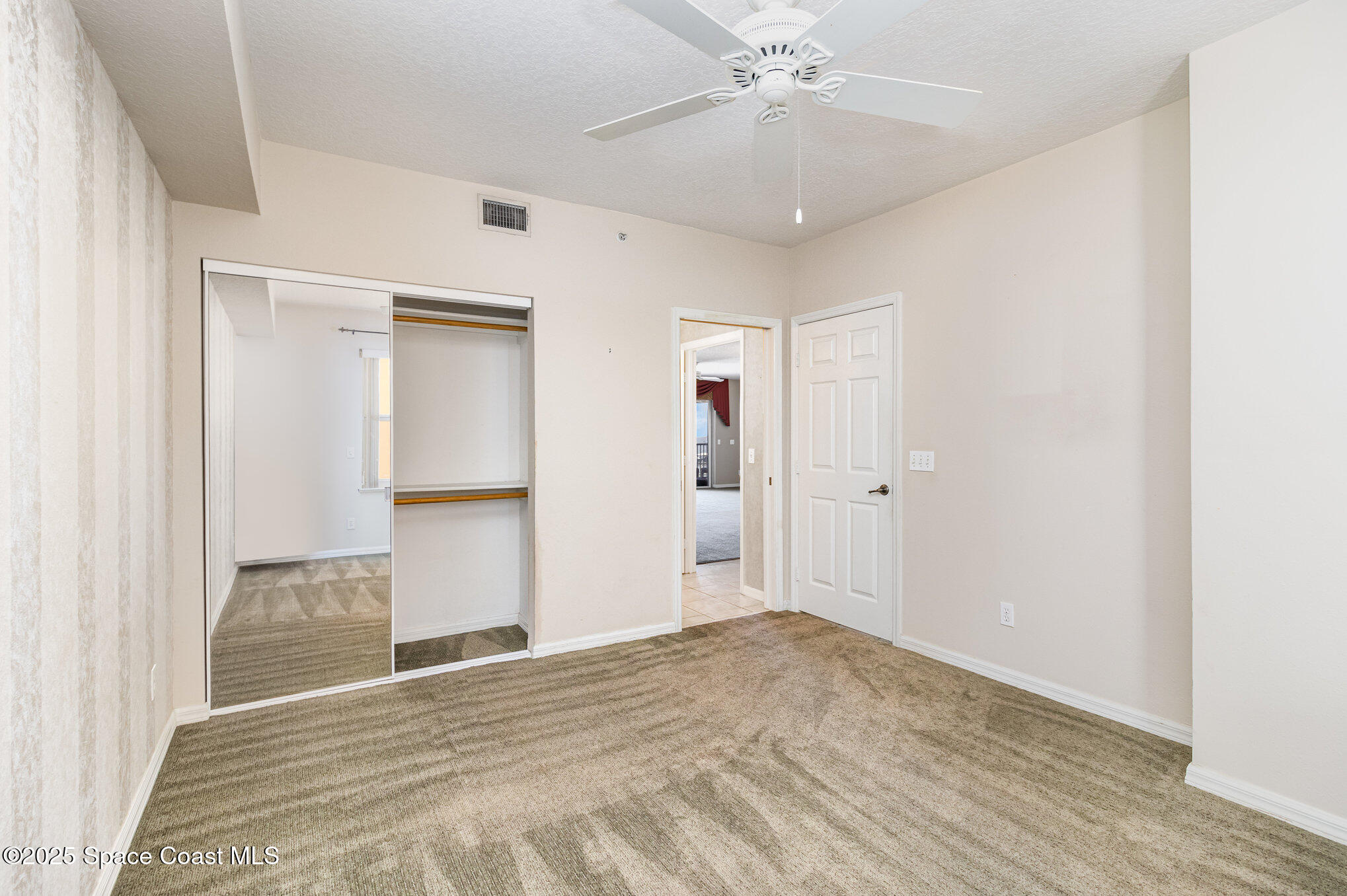 104 Riverside Drive, Unit 403 Cocoa, FL 32922 - Photo 16 of 20 a view of an empty room with wooden floor