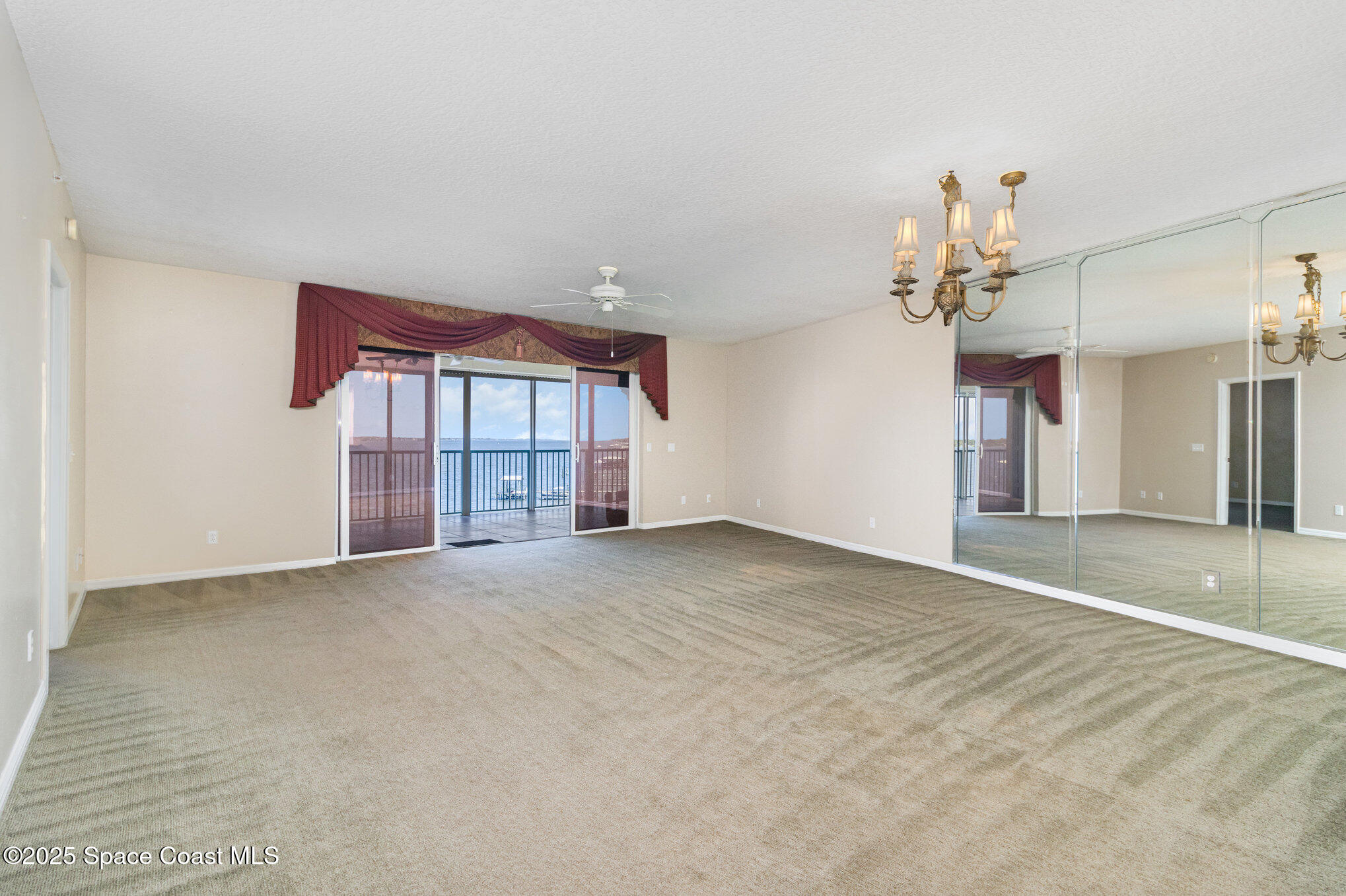 104 Riverside Drive, Unit 403 Cocoa, FL 32922 - Photo 4 of 20 a view of an empty room with a chandelier