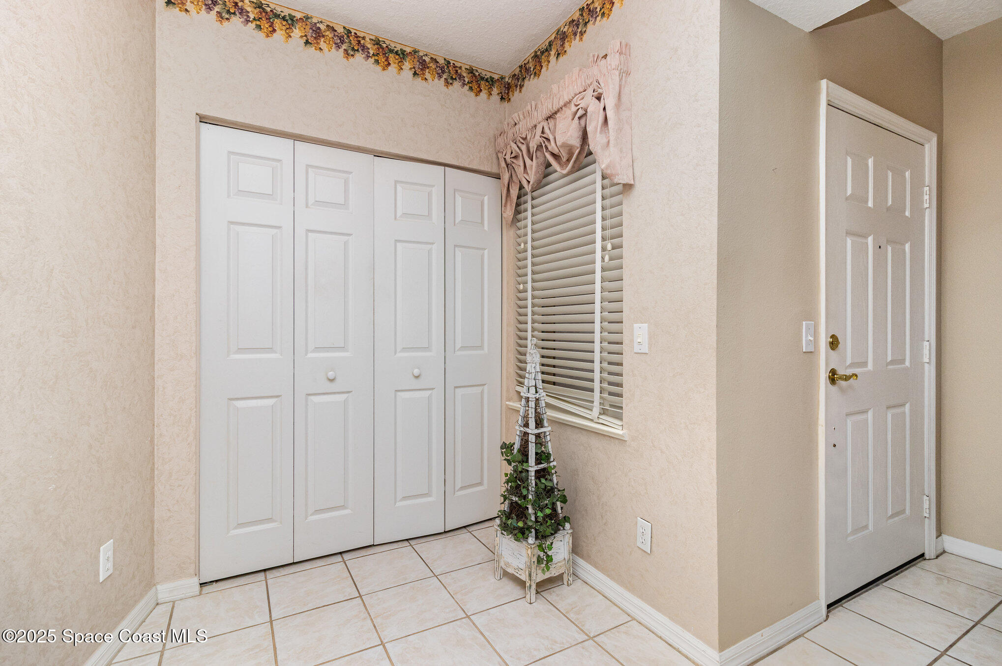 104 Riverside Drive, Unit 403 Cocoa, FL 32922 - Photo 9 of 20 a view of a hallway with wooden floor and a cabinet