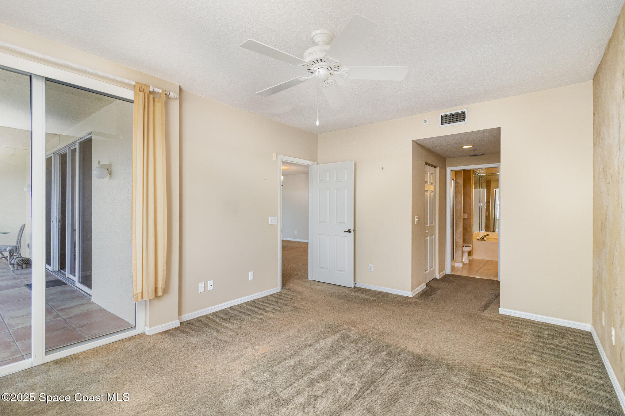 104 Riverside Drive, Unit 403 Cocoa, FL 32922 - Photo 10 of 20 an empty room with closet and a ceiling fan