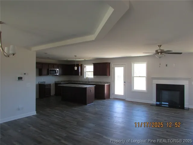 a kitchen with a refrigerator and a stove top oven