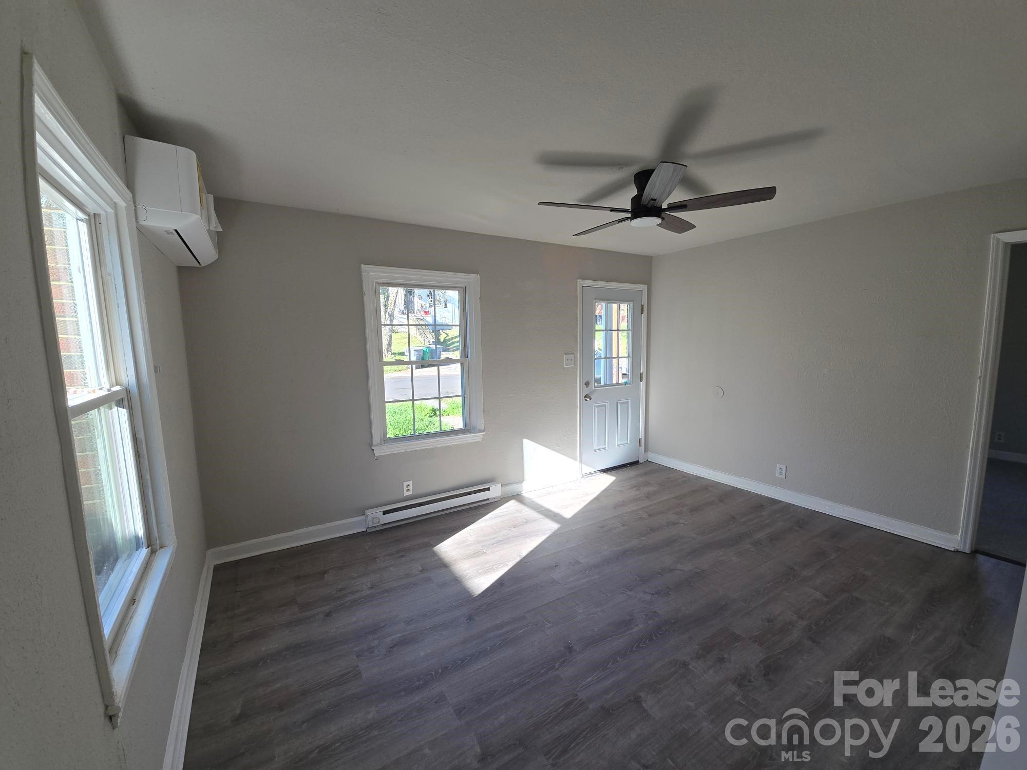 638 Miller Street Charlotte, NC 28203 - Photo 4 of 13 an empty room with wooden floor and windows