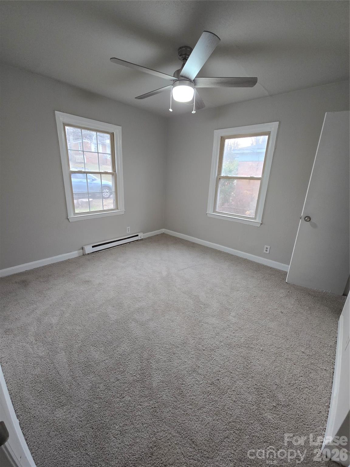 638 Miller Street Charlotte, NC 28203 - Photo 7 of 13 an empty room with windows and fan