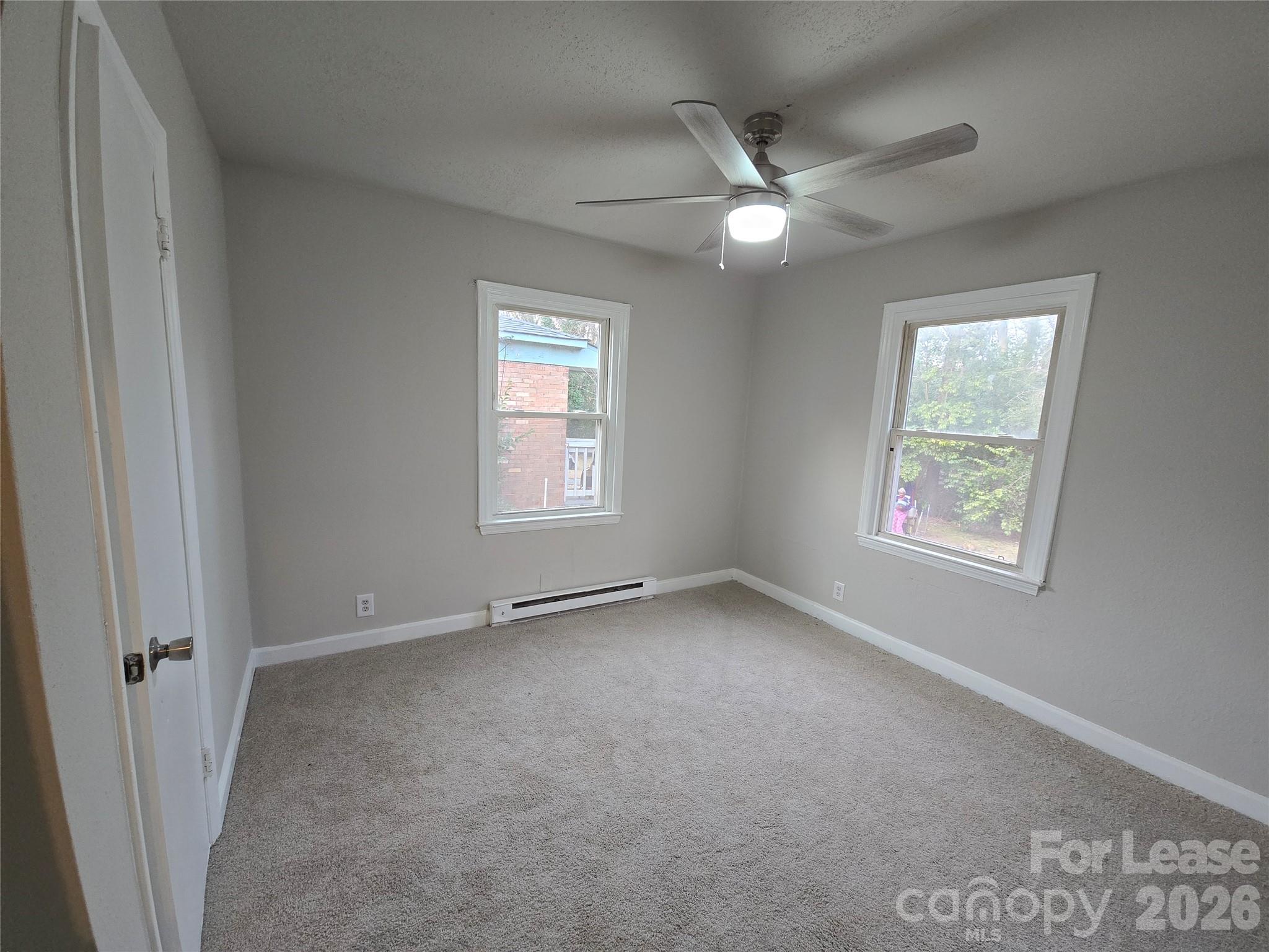 638 Miller Street Charlotte, NC 28203 - Photo 9 of 13 an empty room with a window and a fan