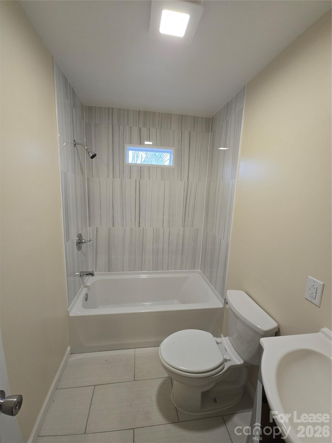 638 Miller Street Charlotte, NC 28203 - Photo 10 of 13 a bathroom with a toilet and a bathtub