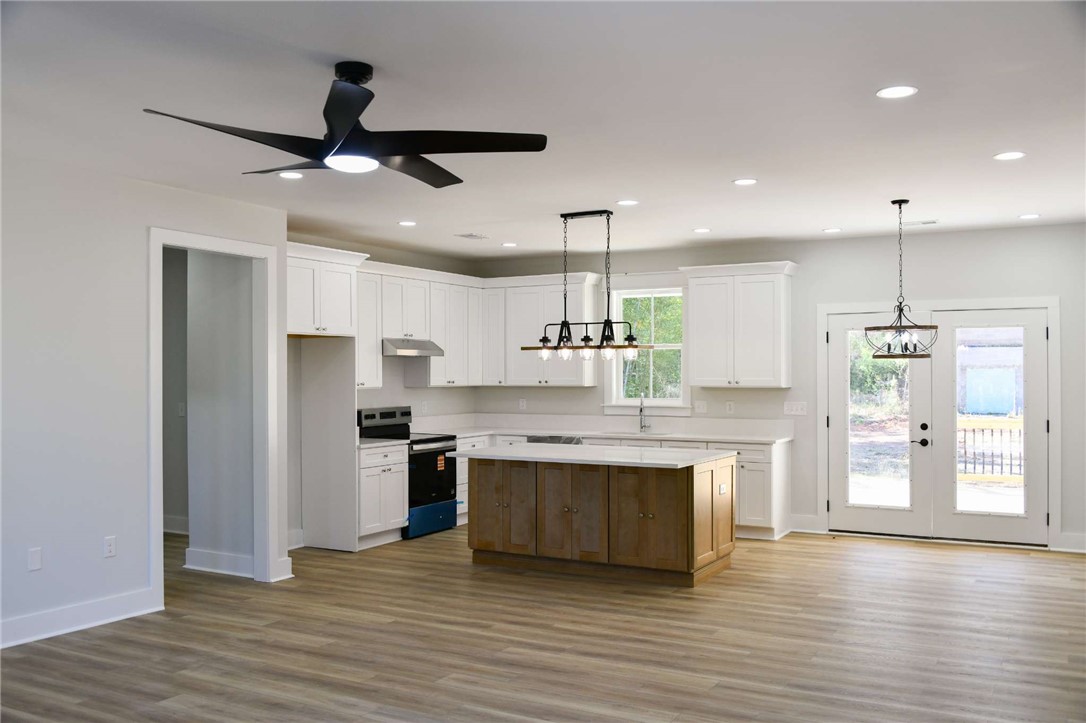 2515 Highway 29 Anderson, SC 29621 - Photo 4 of 38 A pristine open-concept kitchen features a large island and ample natural light from the patio doors.