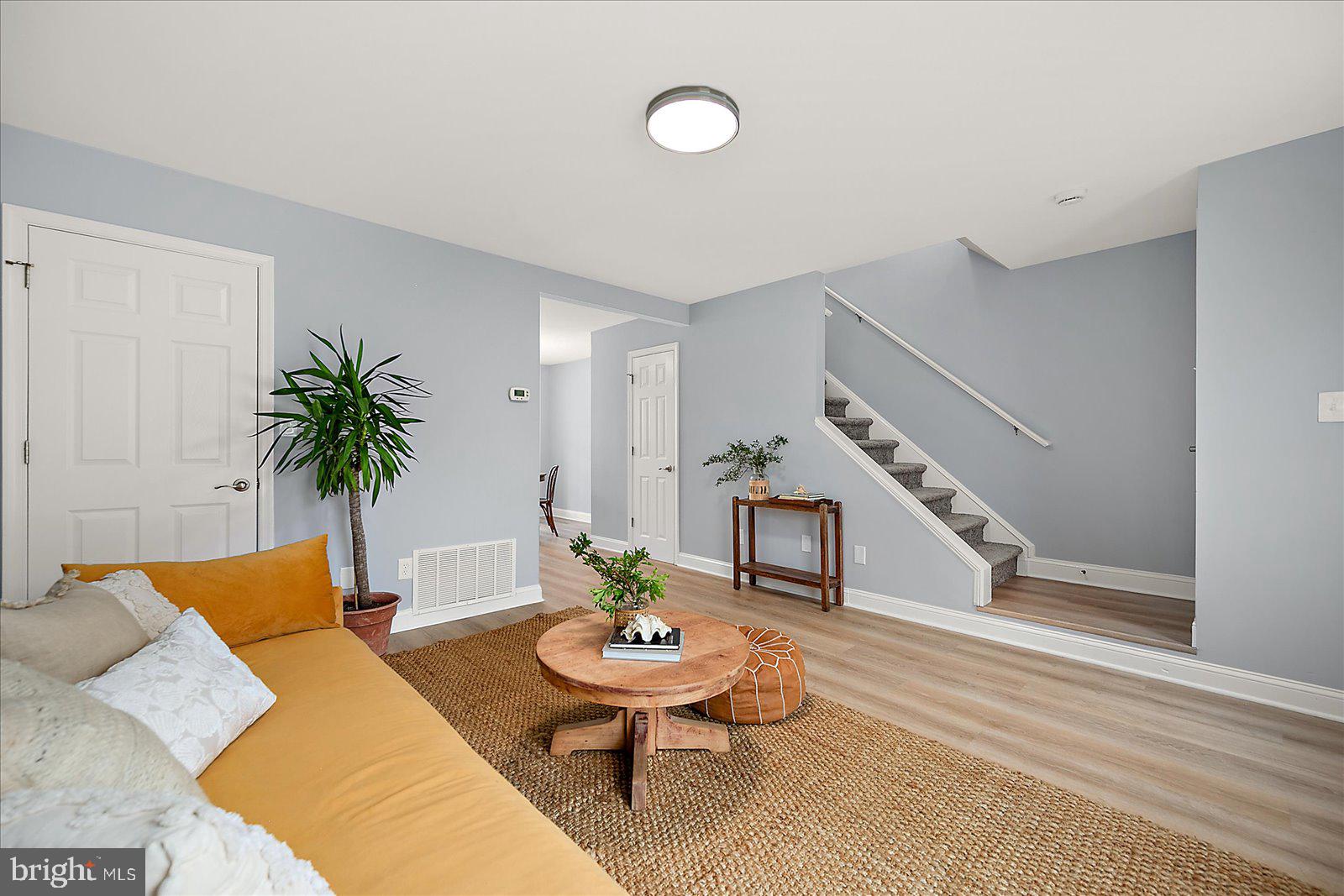 135 Jamestown Road, Unit 18A Ocean City, MD 21842 - Photo 12 of 63 a living room with furniture potted plant and wooden floor