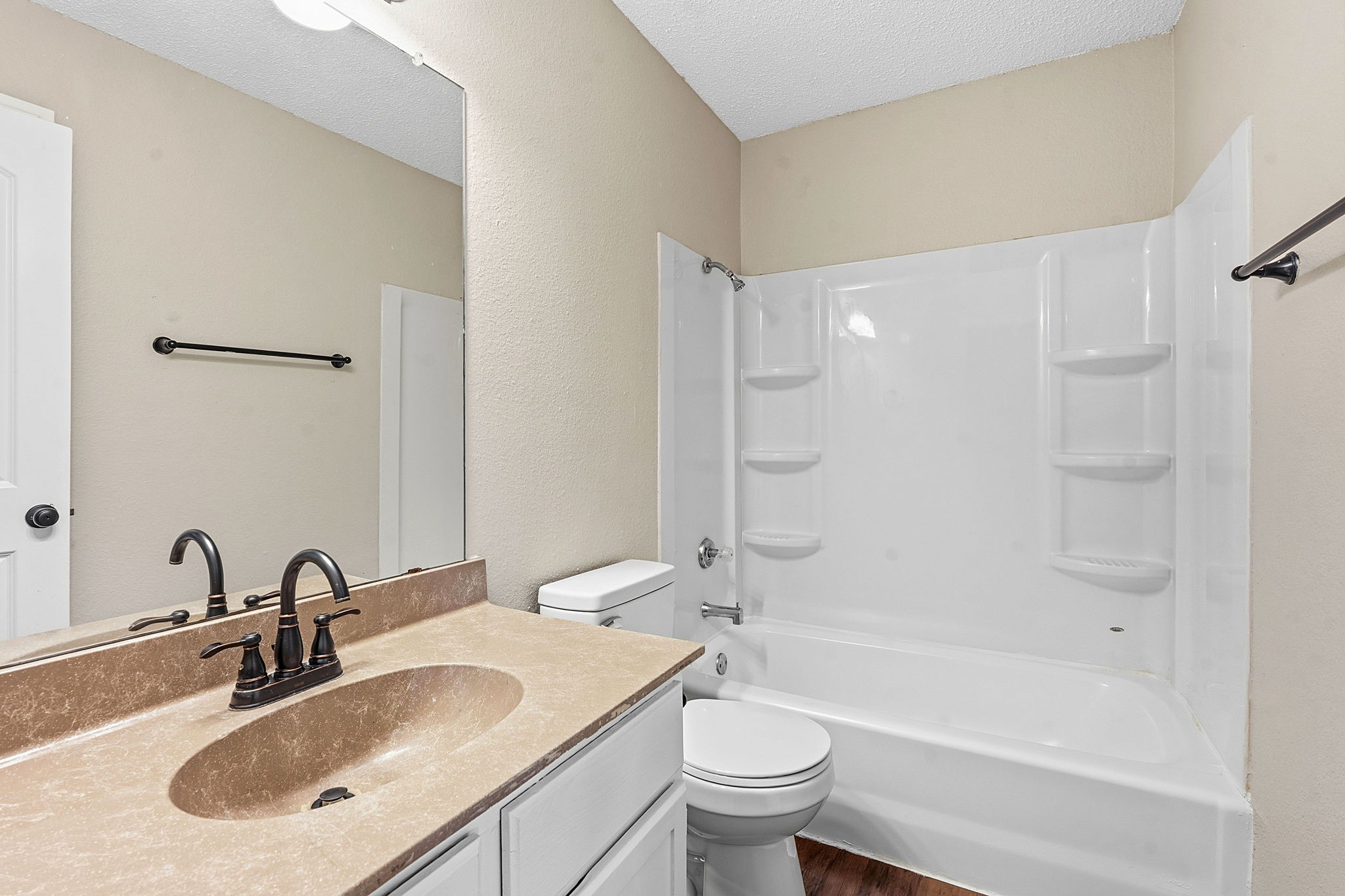 8811 Schick Road Austin, TX 78729 - Photo 21 of 27 Functional full bathroom featuring a tub-shower combination, a vanity with a mirror, and wood-style flooring.