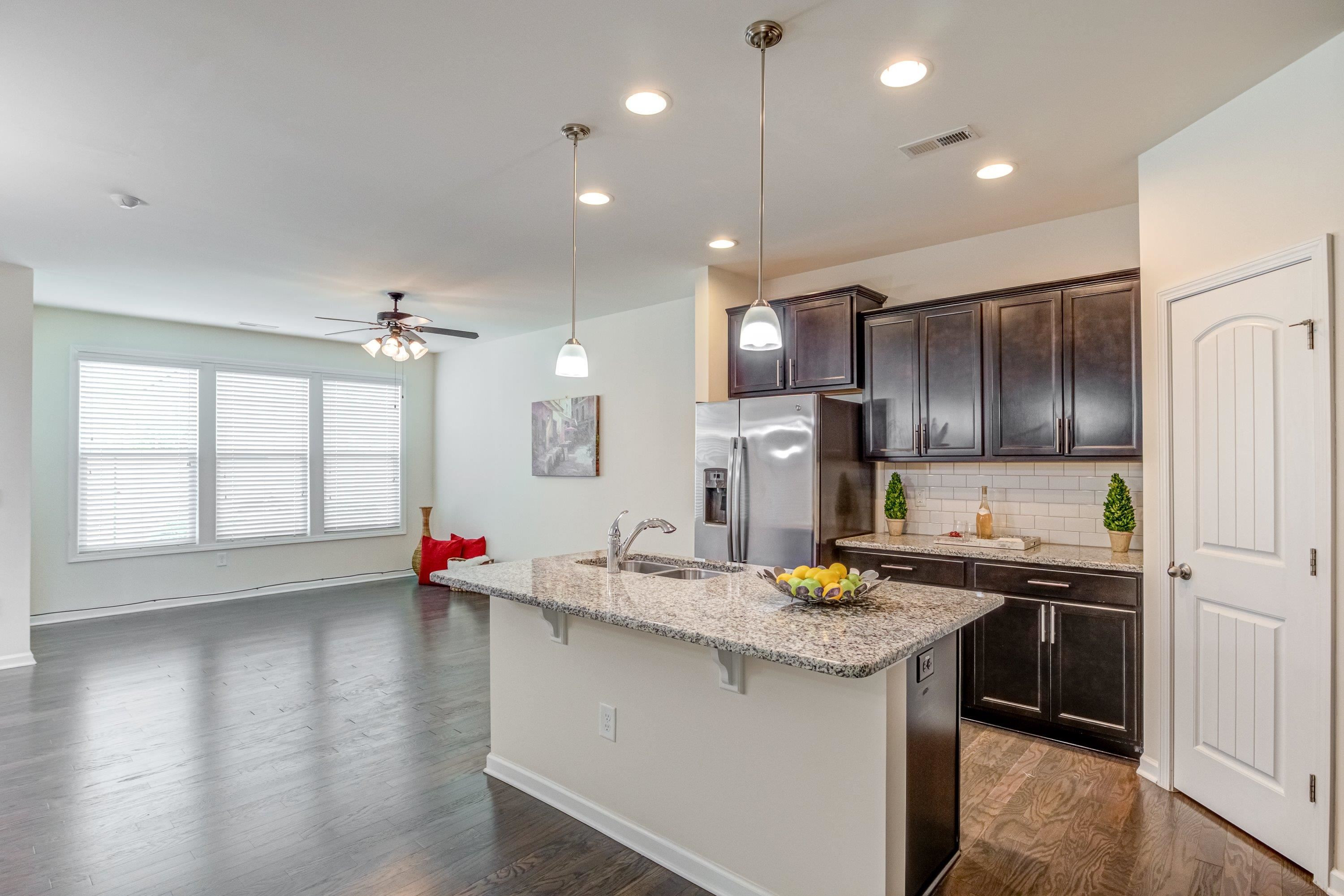 7817 Elmshire Way Raleigh, NC 27616 - Photo 12 of 46 a kitchen with stainless steel appliances granite countertop a sink stove and refrigerator