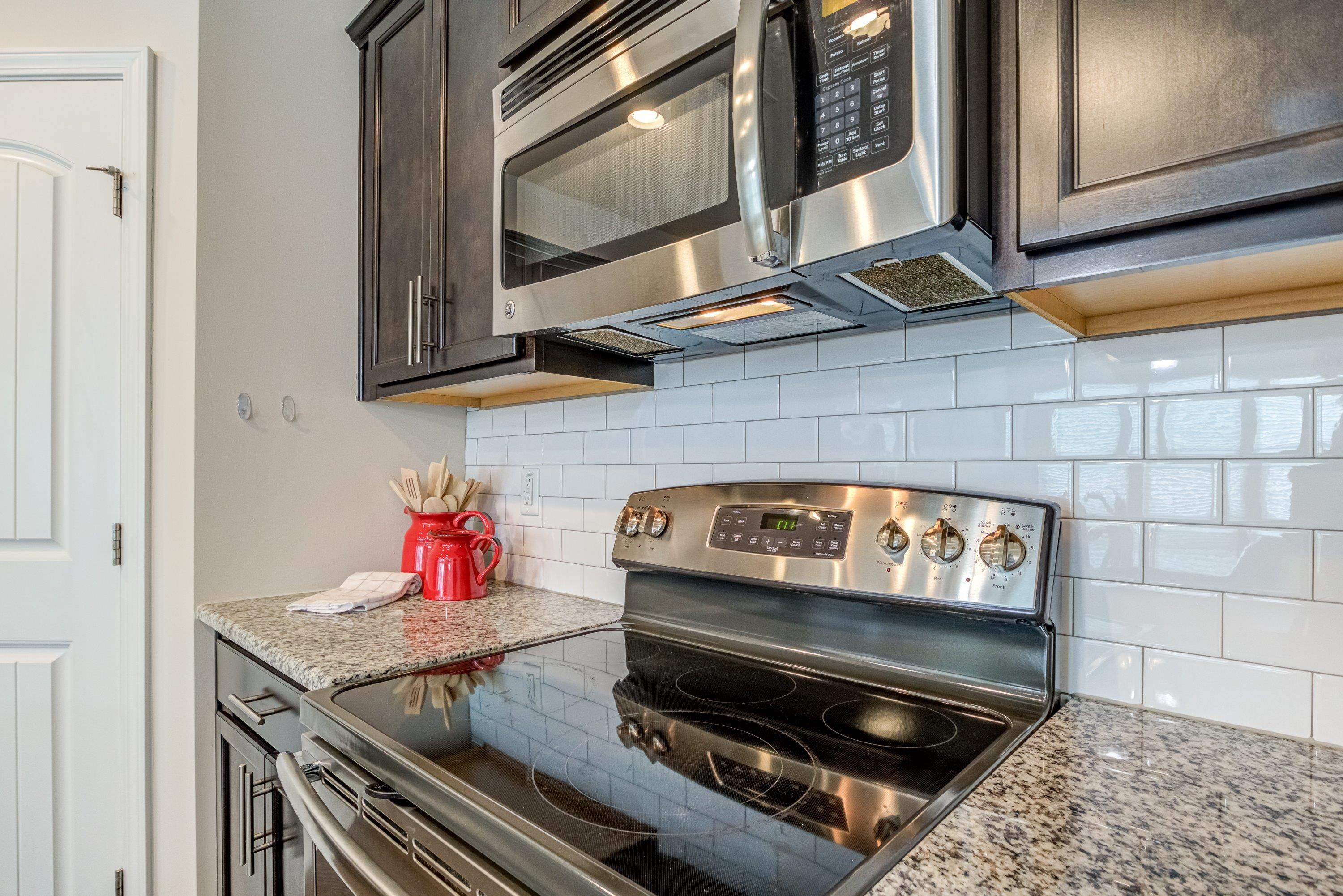 7817 Elmshire Way Raleigh, NC 27616 - Photo 14 of 46 a kitchen with a stove and a microwave