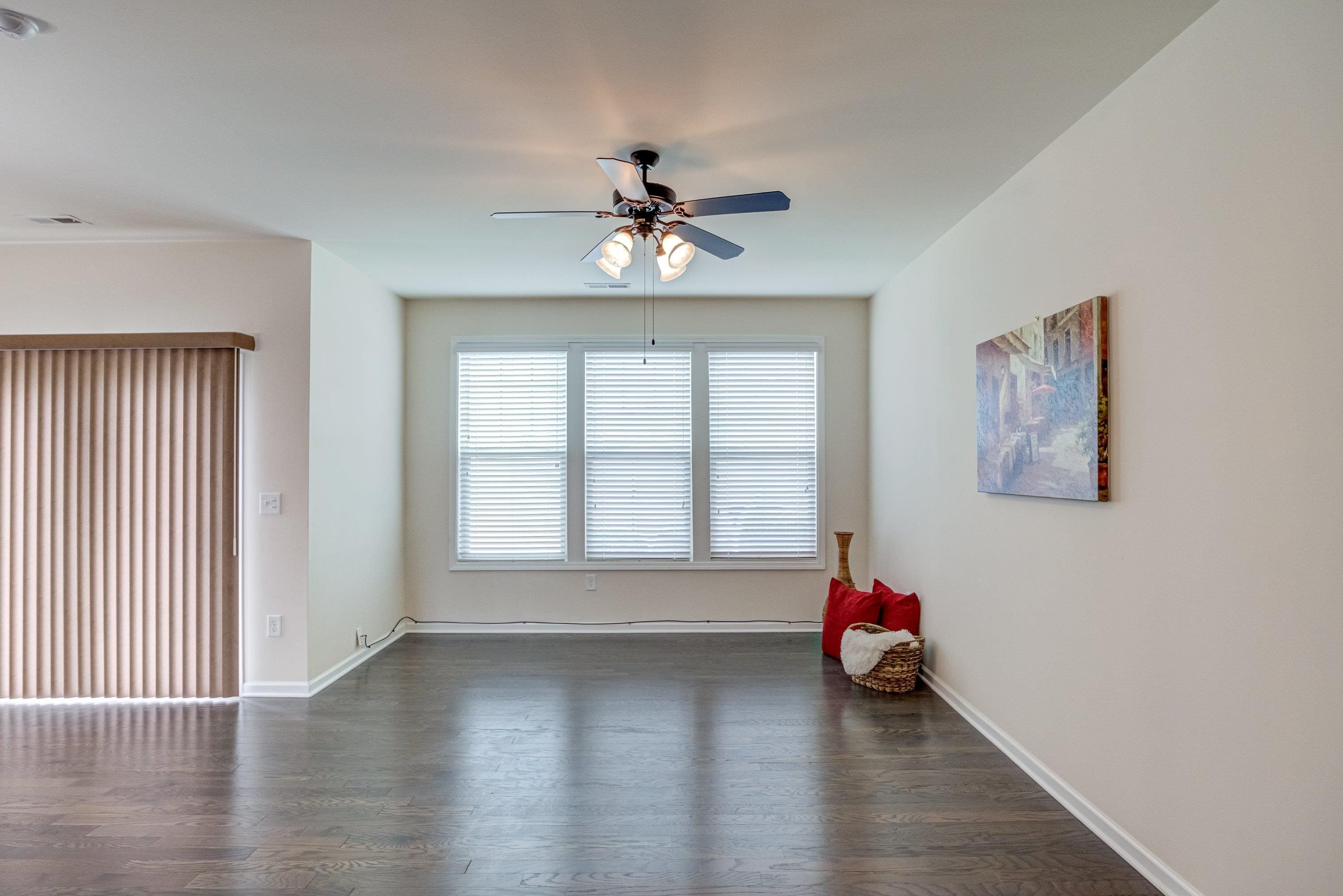 7817 Elmshire Way Raleigh, NC 27616 - Photo 18 of 46 an empty room with windows and ceiling fan