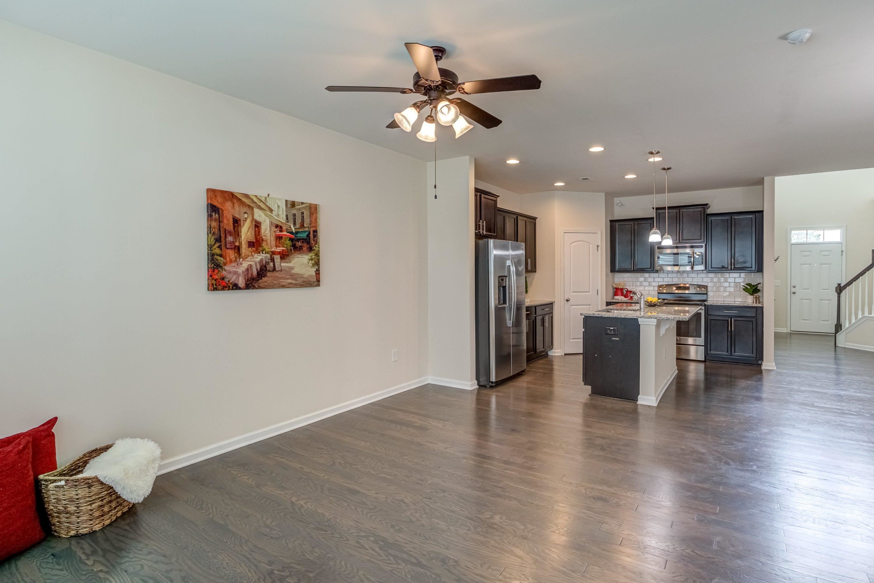 7817 Elmshire Way Raleigh, NC 27616 - Photo 20 of 46 a view of kitchen with stainless steel appliances refrigerator stove microwave and cabinets