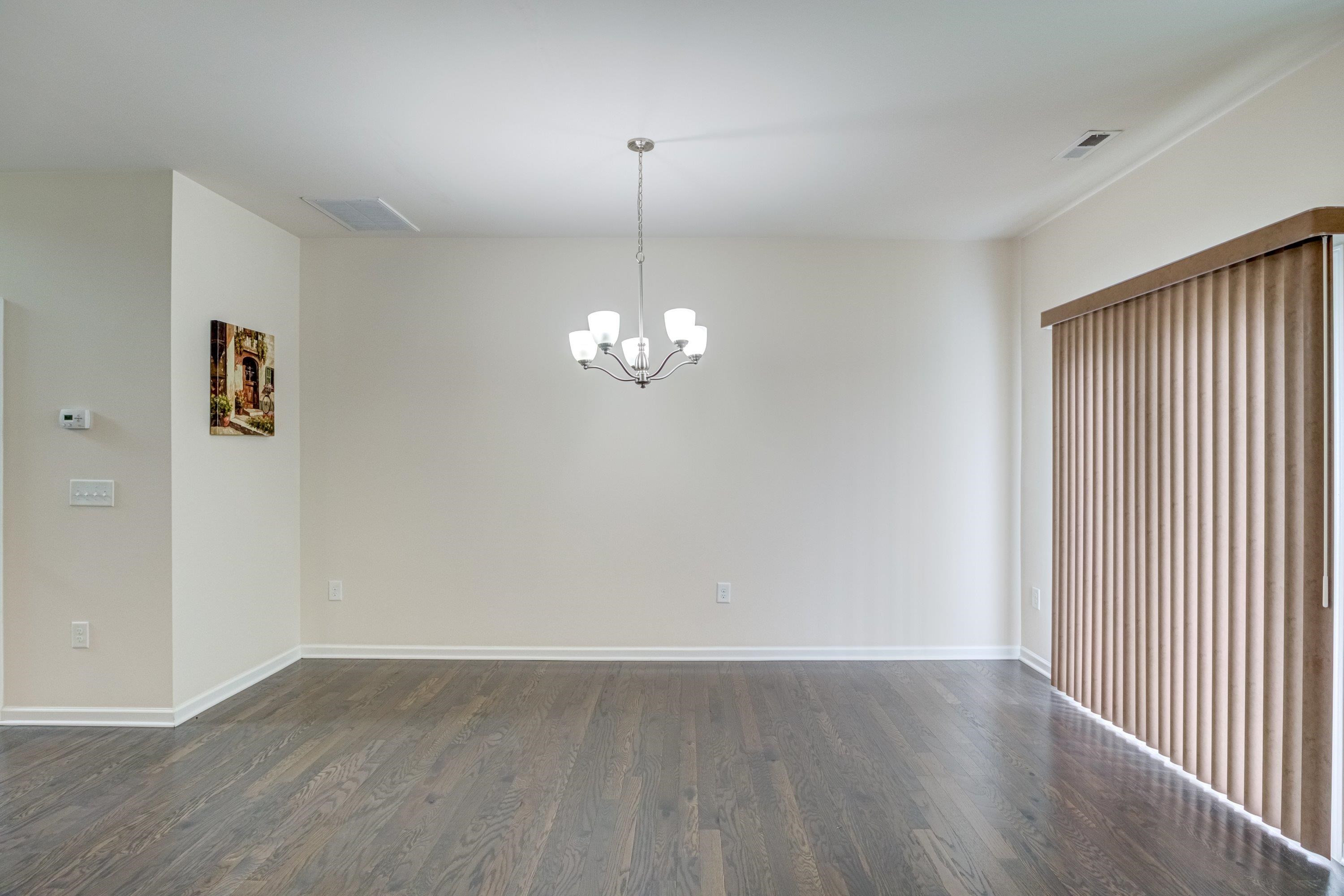 7817 Elmshire Way Raleigh, NC 27616 - Photo 22 of 46 wooden floor in an empty room with a window