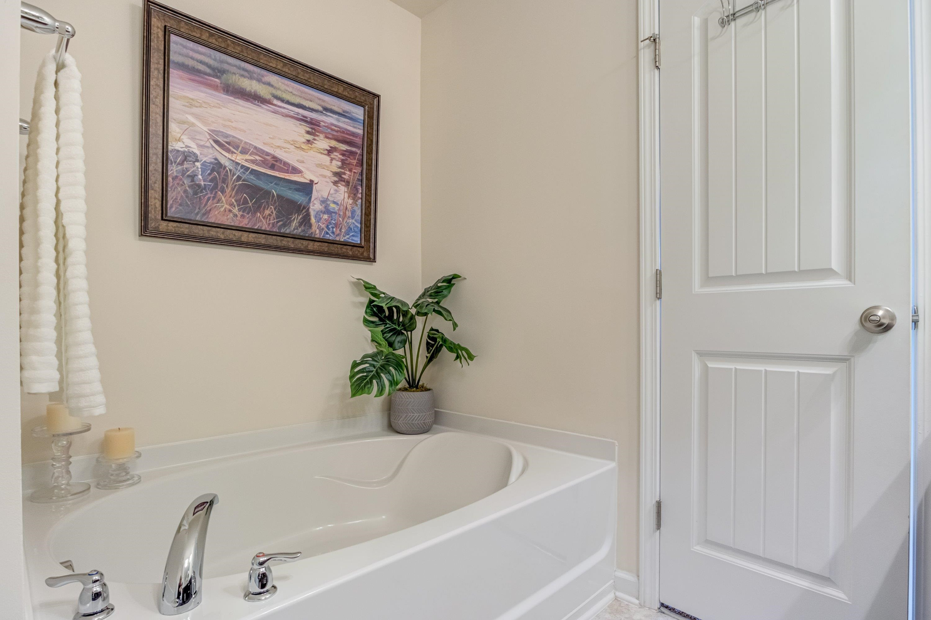 7817 Elmshire Way Raleigh, NC 27616 - Photo 28 of 46 a white bath tub with a shower