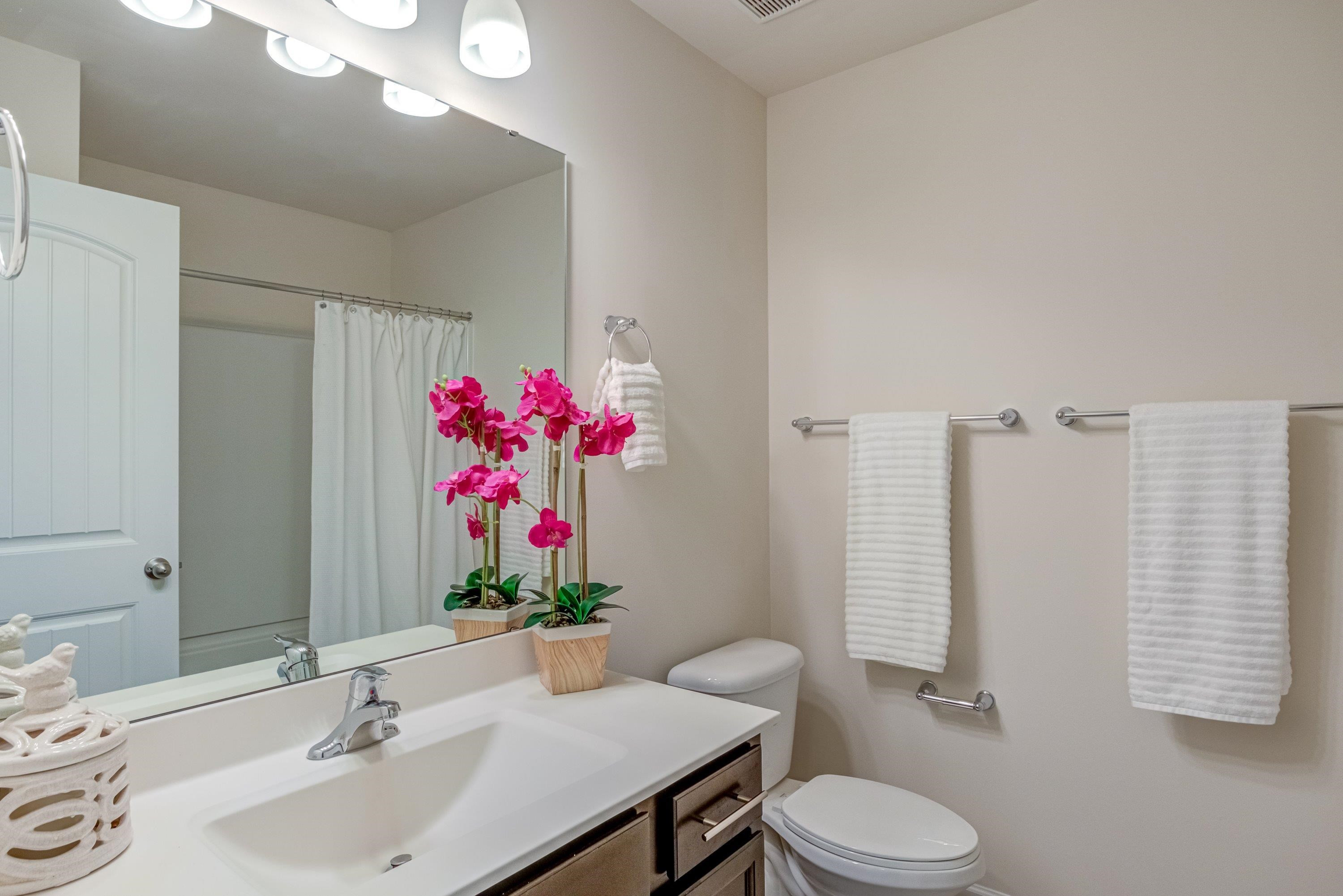 7817 Elmshire Way Raleigh, NC 27616 - Photo 32 of 46 a bathroom with a sink vanity mirror and toilet