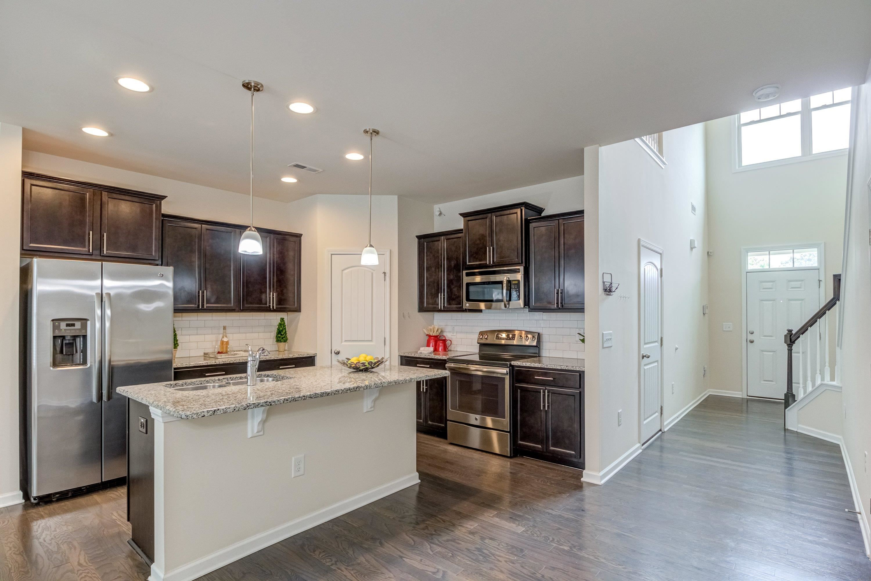 7817 Elmshire Way Raleigh, NC 27616 - Photo 9 of 46 a kitchen that has a lot of cabinets and stainless steel appliances