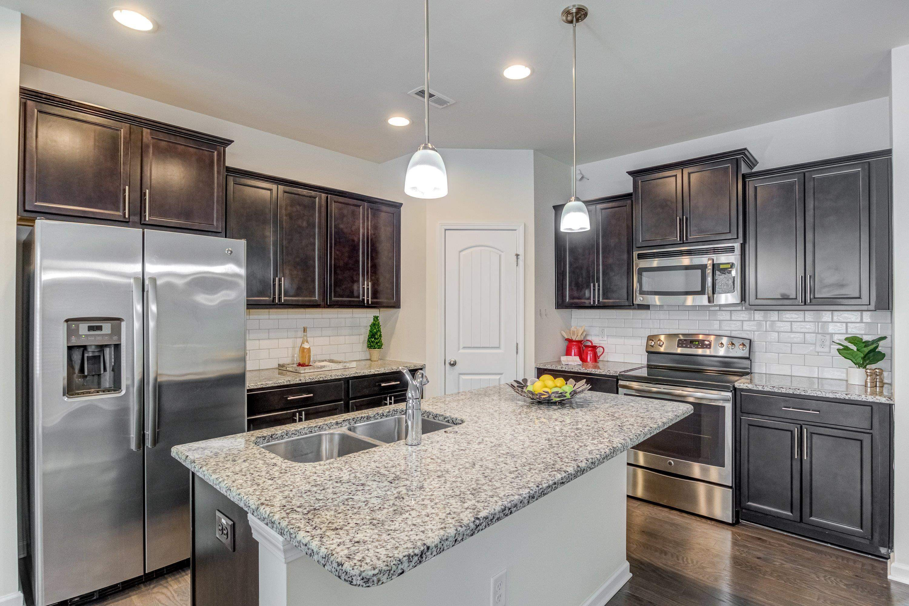 7817 Elmshire Way Raleigh, NC 27616 - Photo 10 of 46 a kitchen with stainless steel appliances granite countertop a sink stove and refrigerator