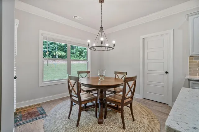 a dining room with furniture a rug and a chandelier