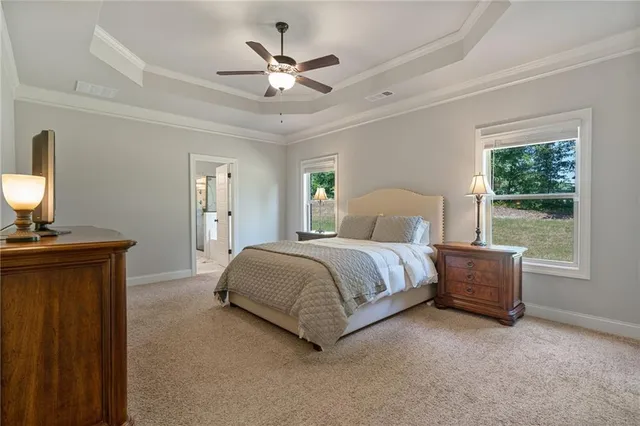 a bedroom with a large bed and a chandelier