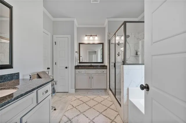 a spacious bathroom with a granite countertop sink and a mirror