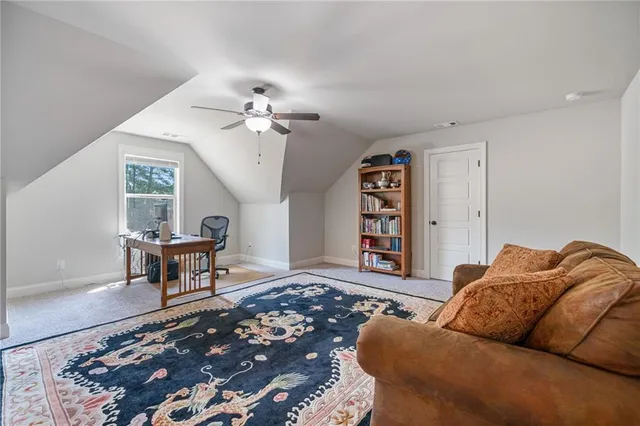 a living room with furniture a rug and a chandelier