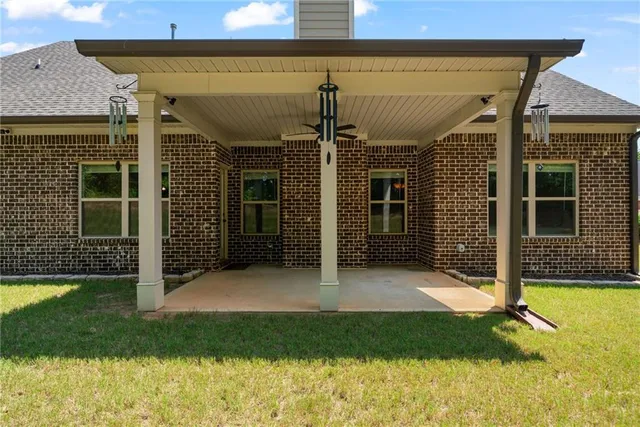 a front view of a house with a yard and trees