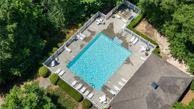 an aerial view of a house with a yard and lake view