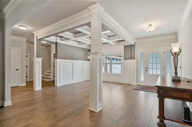 a view of a big room with wooden floor and a kitchen