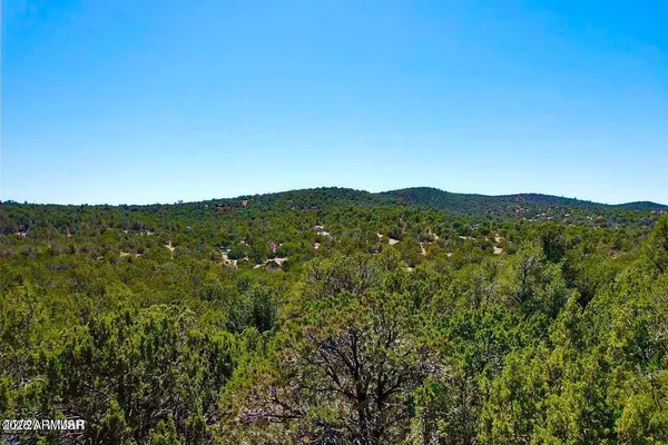 a view of a large mountain with mountains in the background