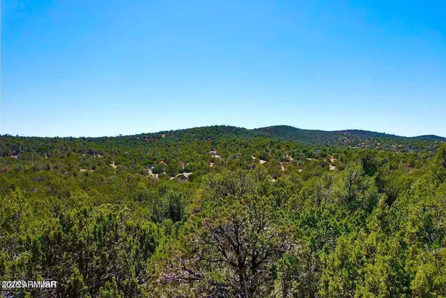 a view of a large mountain with mountains in the background