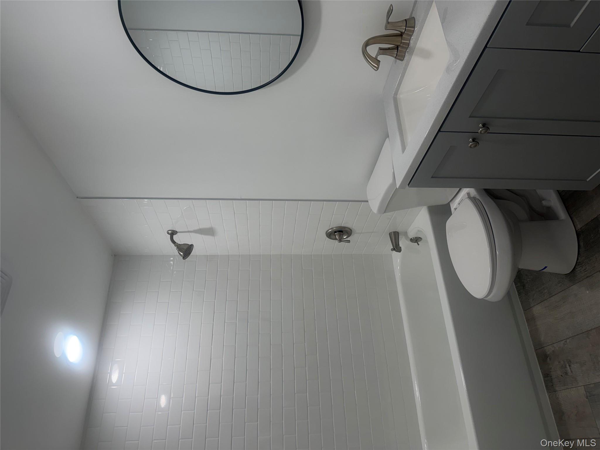 7 Filmore Avenue Coram, NY 11727 - Photo 11 of 22 a bathroom with a sink a toilet and a mirror