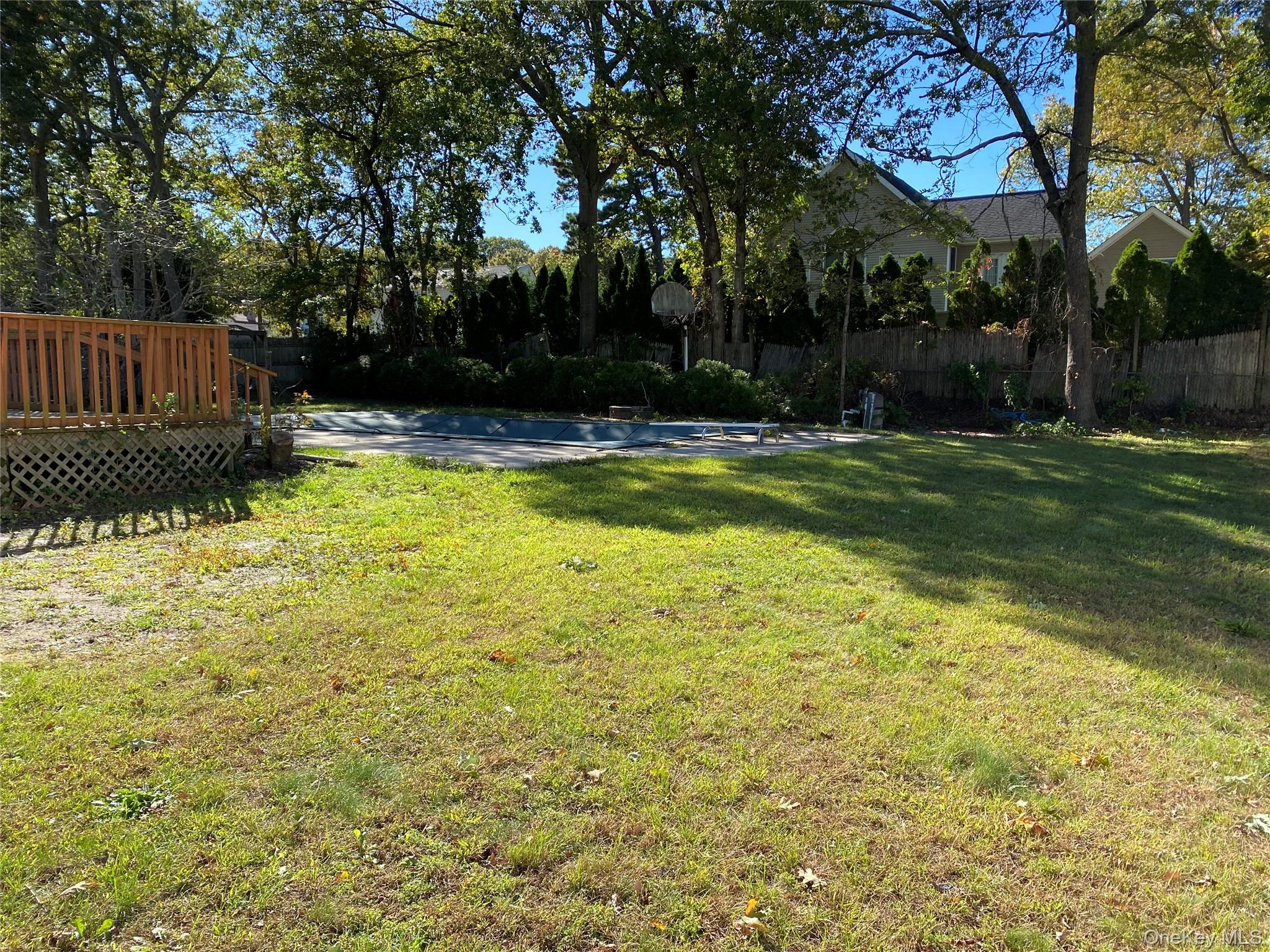 7 Filmore Avenue Coram, NY 11727 - Photo 21 of 22 a view of swimming pool with table and chairs and wooden fence