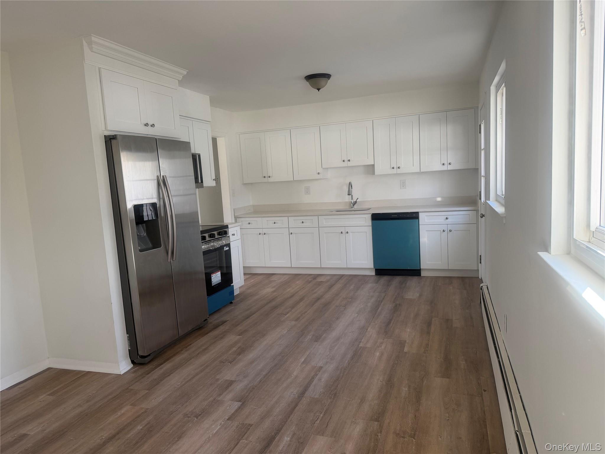 7 Filmore Avenue Coram, NY 11727 - Photo 9 of 22 a kitchen with a refrigerator sink and cabinets