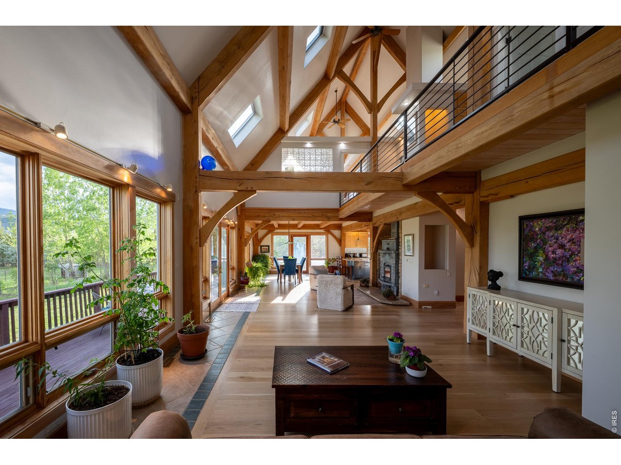 4099 Michaud Lane Fort Collins, CO 80521 - Photo 25 of 50 As you relax in the living room, your eyes are naturally drawn upward to a breathtaking display of the beautifully crafted beams, a true work of art, thoughtfully shaped and assembled by hand using a traditional wooden mallet.