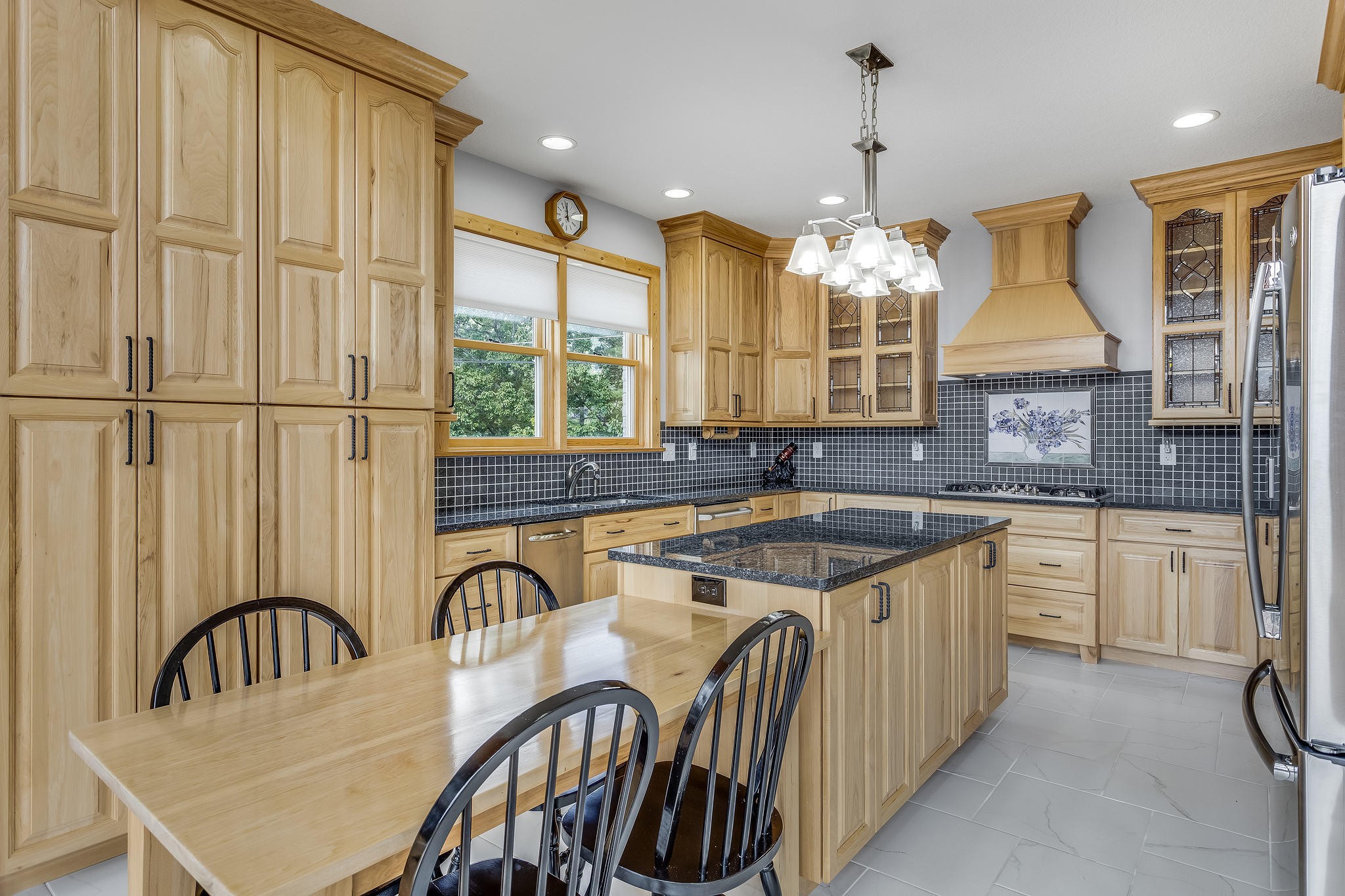 163 Kelly Ridge Road Townsend, TN 37882 - Photo 14 of 40 a kitchen with stainless steel appliances granite countertop a stove a sink dishwasher a dining table and chairs with wooden floor