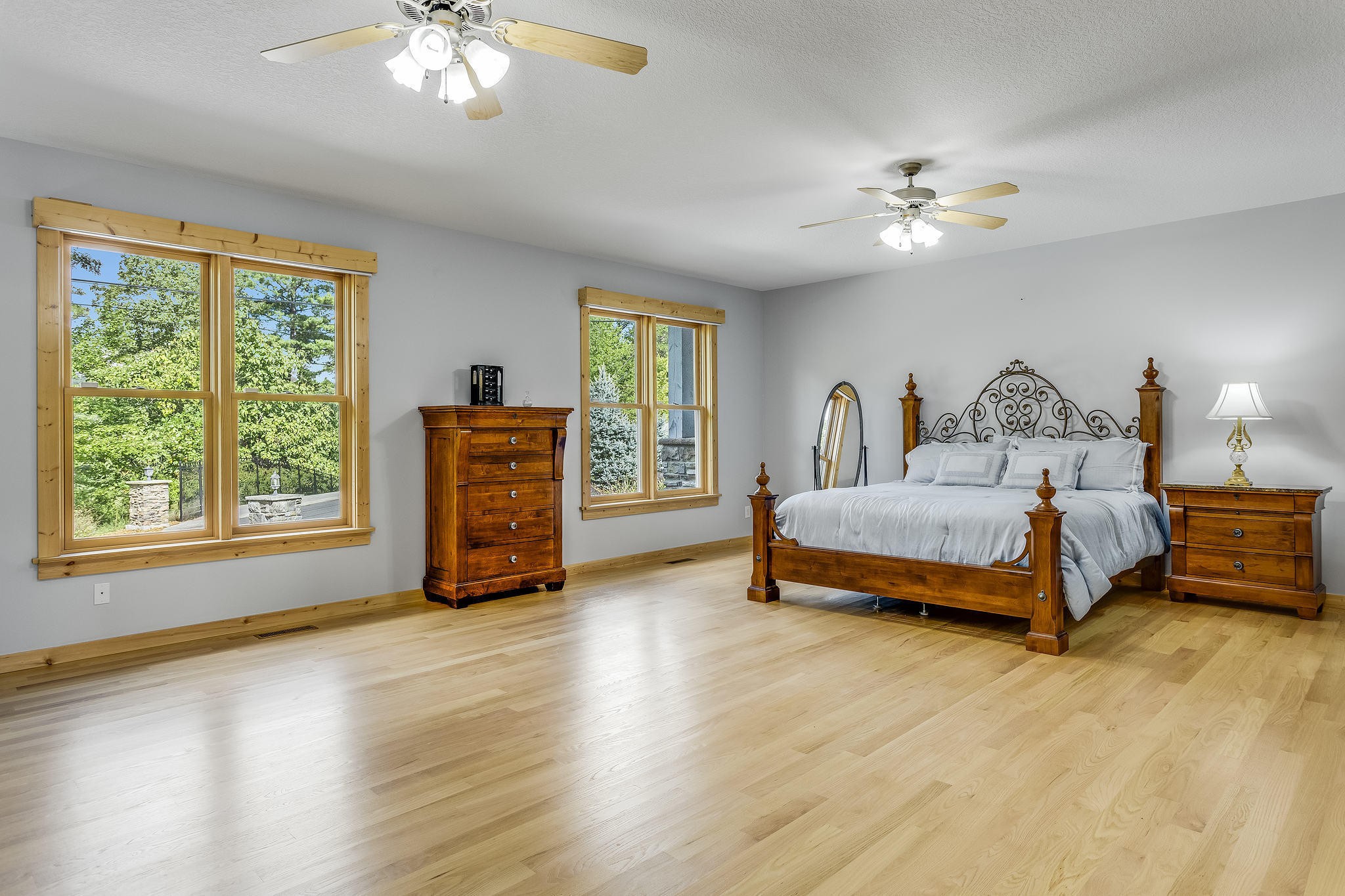 163 Kelly Ridge Road Townsend, TN 37882 - Photo 17 of 40 a spacious bedroom with a bed a chandelier and a window