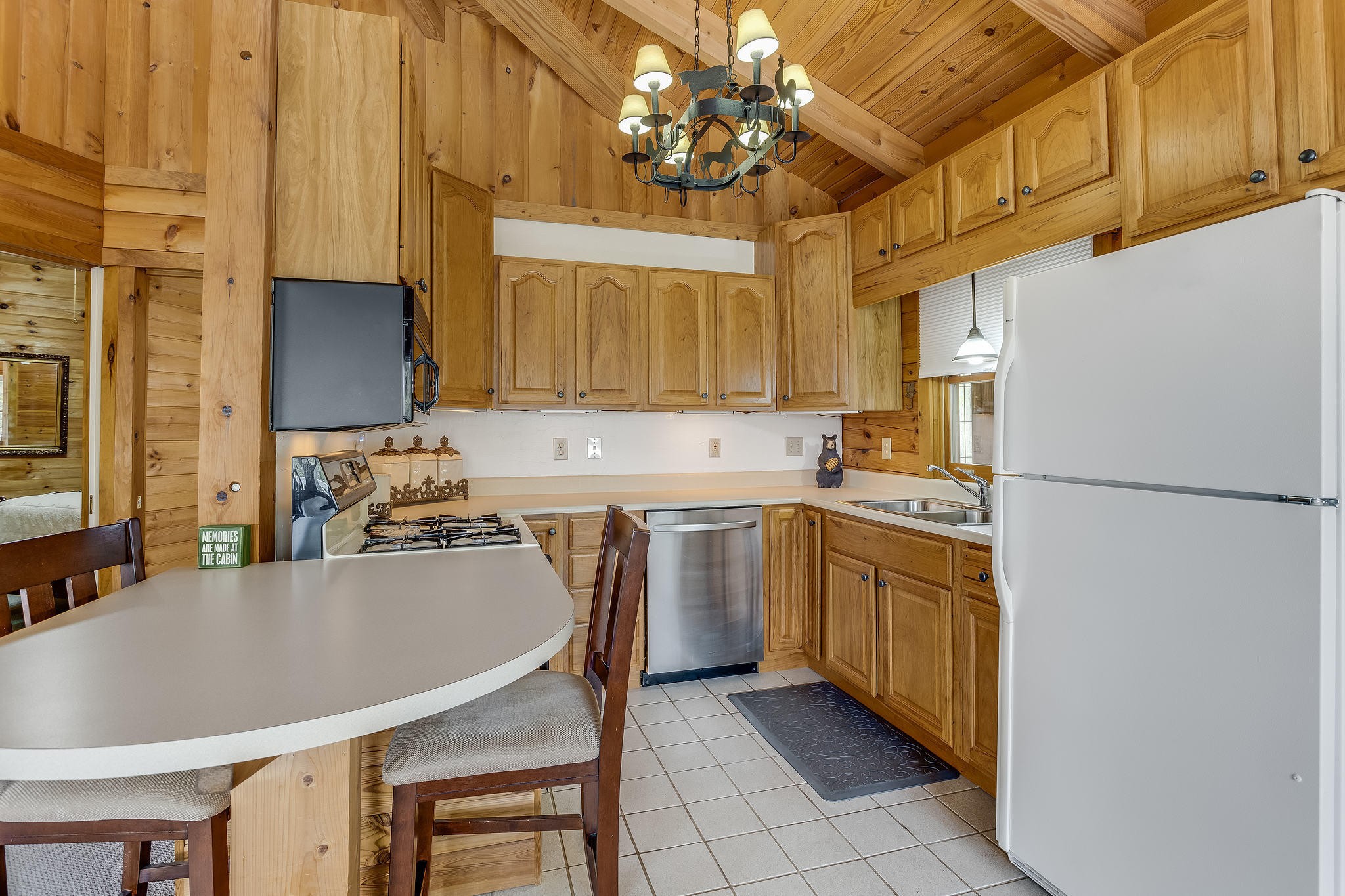 163 Kelly Ridge Road Townsend, TN 37882 - Photo 31 of 40 a kitchen with stainless steel appliances granite countertop a refrigerator a stove a sink dishwasher and a microwave with cabinets