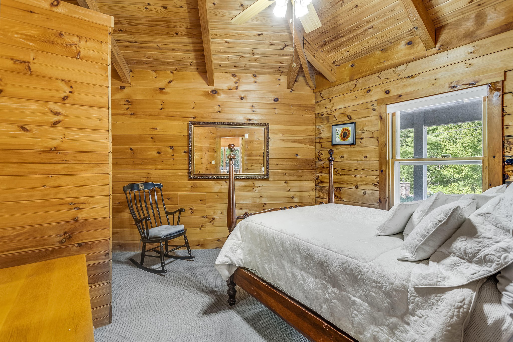 163 Kelly Ridge Road Townsend, TN 37882 - Photo 32 of 40 a bed sitting in a bedroom next to a brick wall