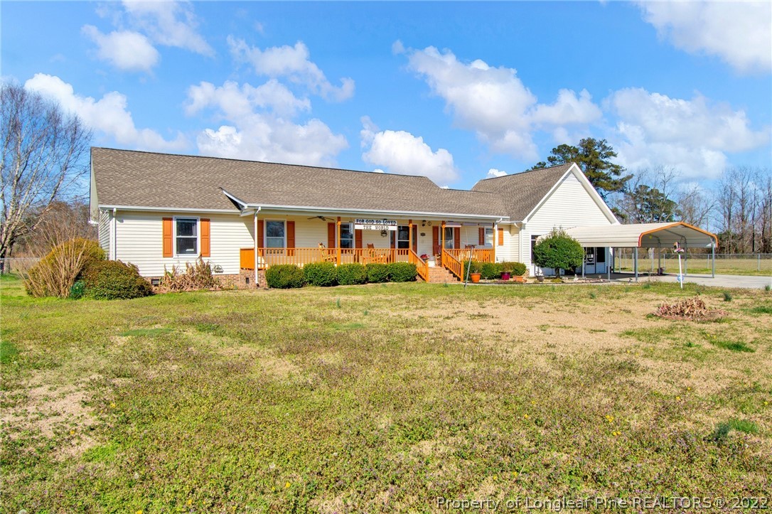 1197 Rowan Road Lumberton, NC 28358 - Photo 1 of 37 a front view of a house with garden