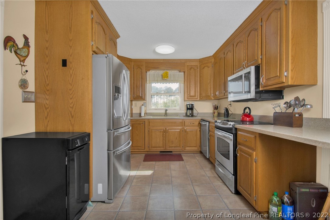 1197 Rowan Road Lumberton, NC 28358 - Photo 14 of 37 a kitchen with a sink cabinets and appliances