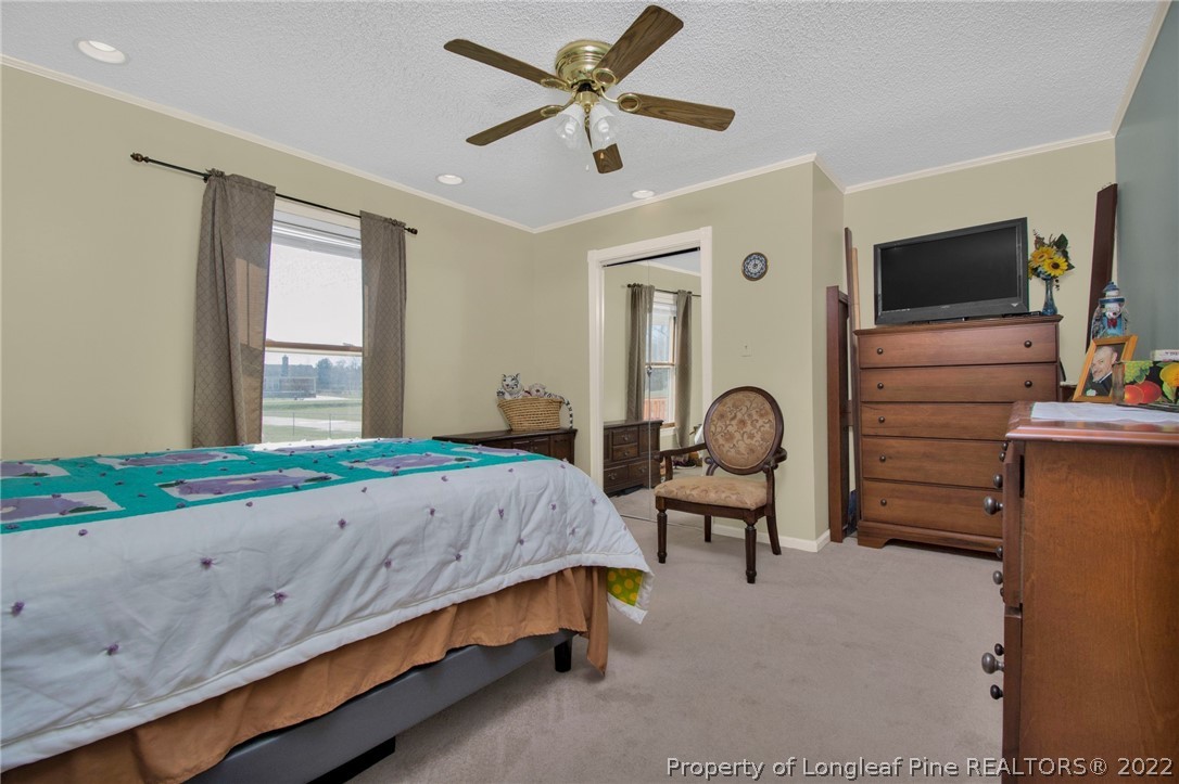 1197 Rowan Road Lumberton, NC 28358 - Photo 23 of 37 a bedroom with a bed and a flat screen tv