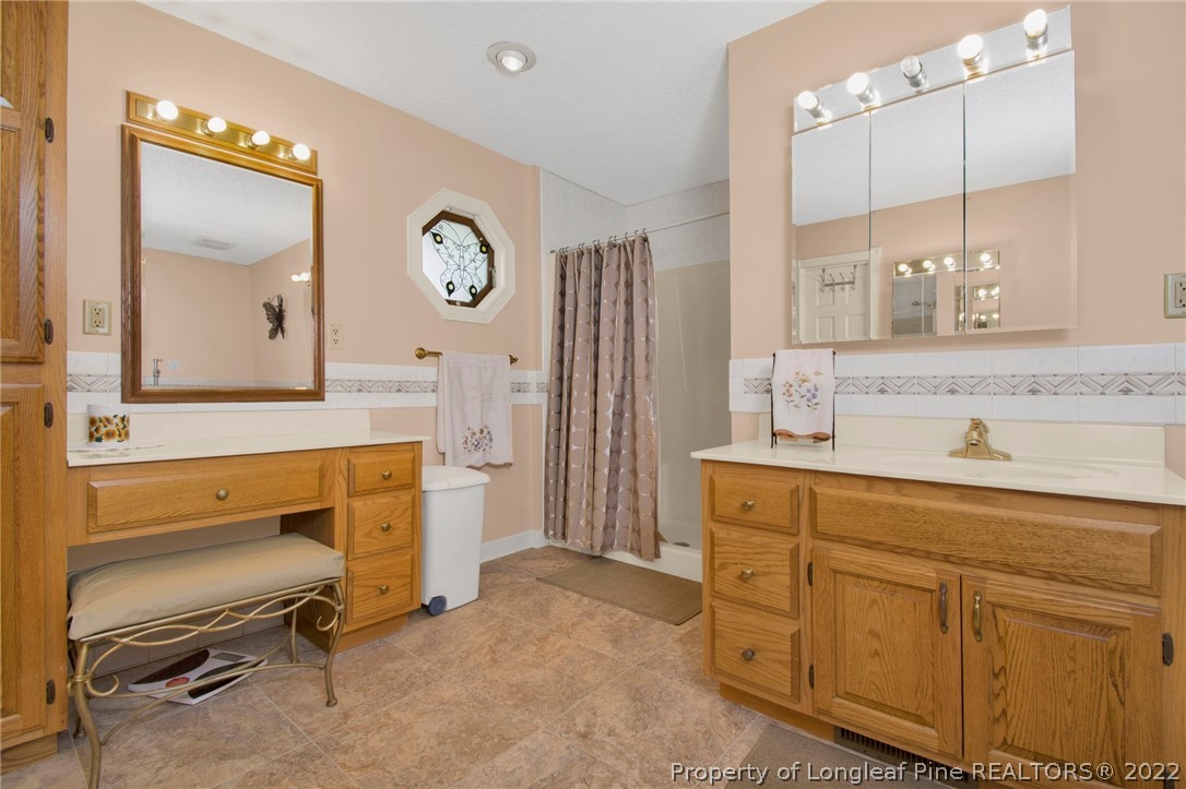 1197 Rowan Road Lumberton, NC 28358 - Photo 28 of 37 a spacious bathroom with a double vanity sink and a mirror