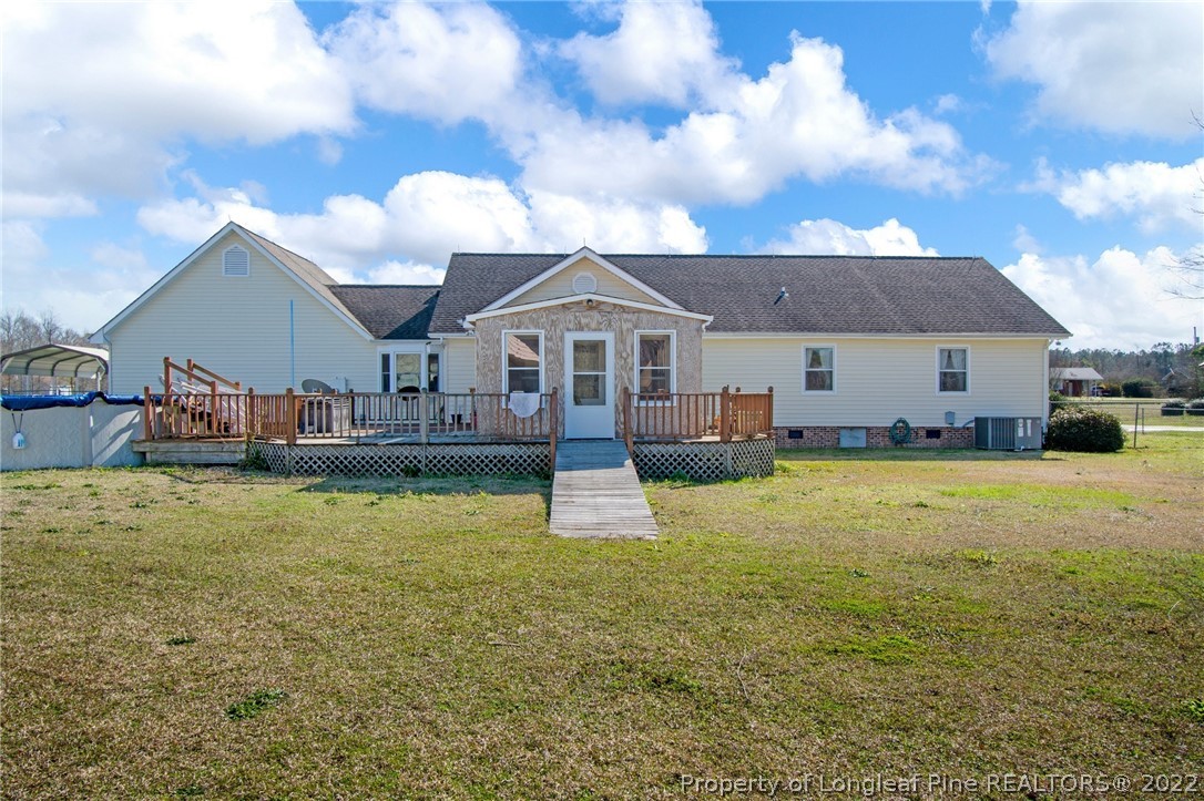 1197 Rowan Road Lumberton, NC 28358 - Photo 33 of 37 a front view of a house with swimming pool and fire pit
