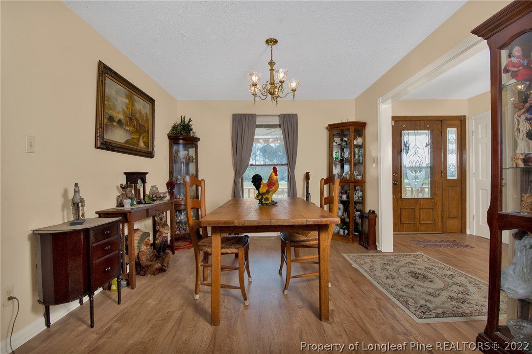1197 Rowan Road Lumberton, NC 28358 - Photo 7 of 37 a view of a dining room with furniture and wooden floor