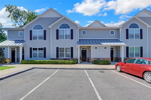a living room with furniture a rug and a window
